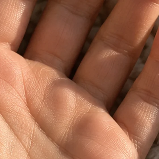 Close-up of fingers on the original photo